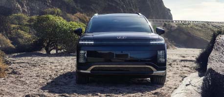 Black_hyundai_suv_parked_on_beach_near_mountain.jpg